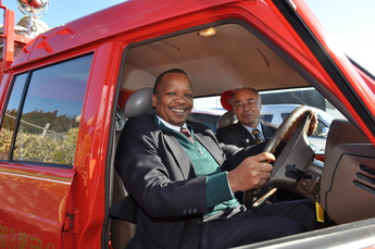 寄贈した消防車とタンザニア参事官の写真