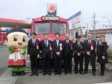 ボンネットバスの前で記念撮影をする町長らの写真