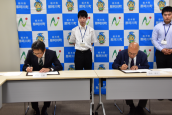 協定書にサインしている写真