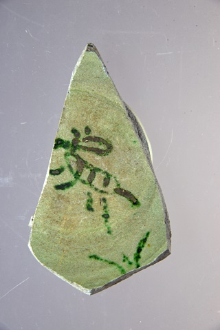 トラの描画がある緑釉陶器片の写真